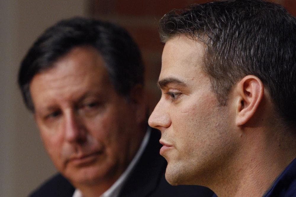 Red Sox owner Tom Werner, left, listens as general manager Theo Epstein speaks during a news conference Friday. (AP)