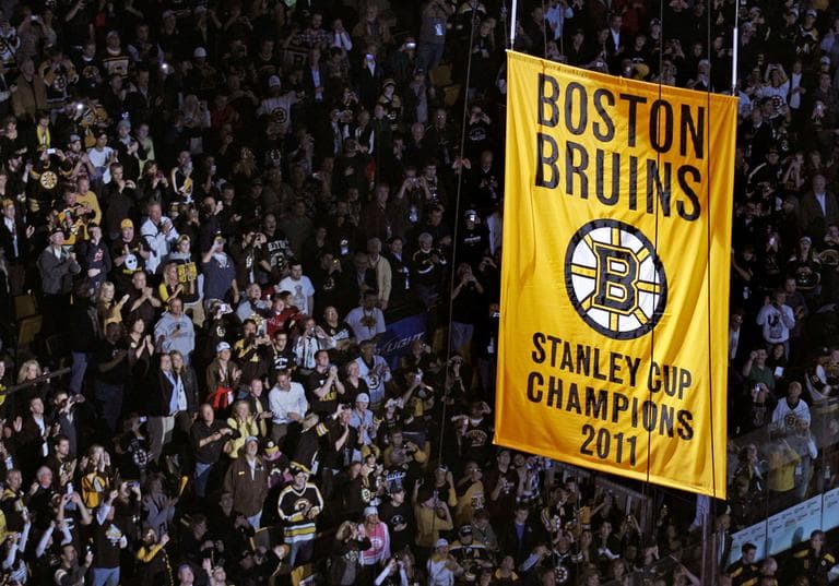Fans applaud as the Stanley Cup banner is hoisted to the rafters of the Boston Garden on Thursday. (AP)