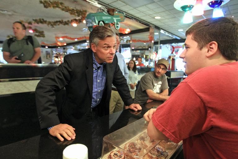 Republican 2012 presidential hopeful, Former Utah Gov. Jon Huntsman, left, listens to waiter Will Cossey of Merrimack, N.H., during a meet and greet at Joey's Diner in Amherst, N.H., Saturday, Sept. 24, 2011.  (AP)