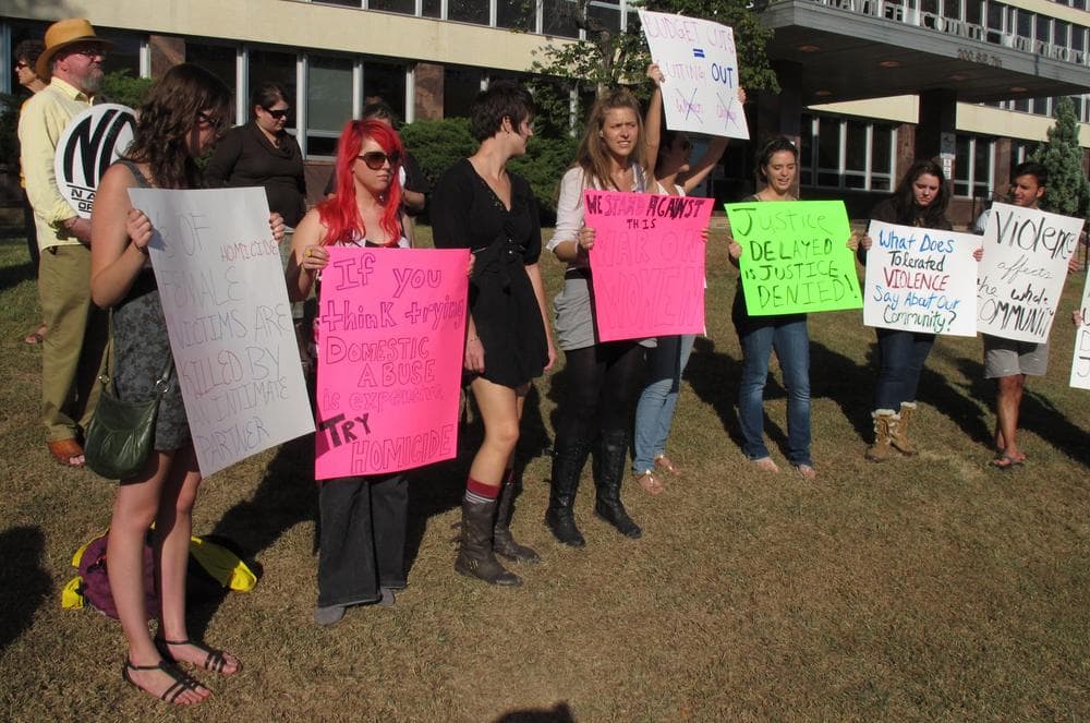 Protesters gather outside the Shawnee County Courthouse over a decision by District Attorney Chad Taylor to stop pursuing domestic violence and other misdemeanor cases, Tuesday. (AP)
