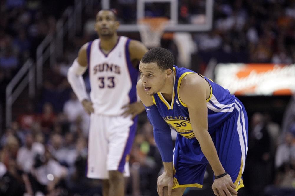 Golden State Warriors guard Stephen Curry rests during a pre-lockout game against the Phoenix Suns in March. (AP)