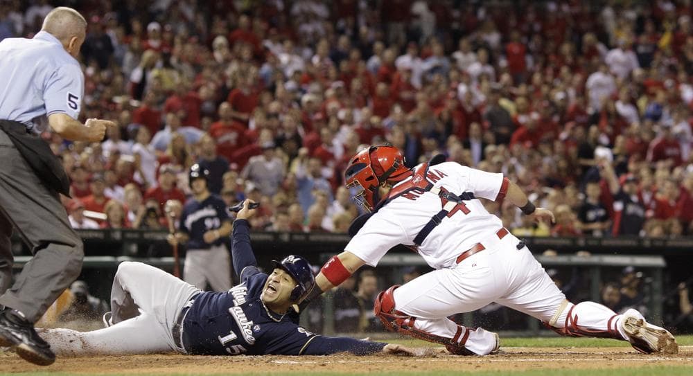 Jerry Hairston Jr. of the Brewers slides safely past Cardinals catcher Yadier Molina during the fourth inning of the NLCS Game 4 on Thursday. The Brewers won 4-2, tying the series at 2. (AP)