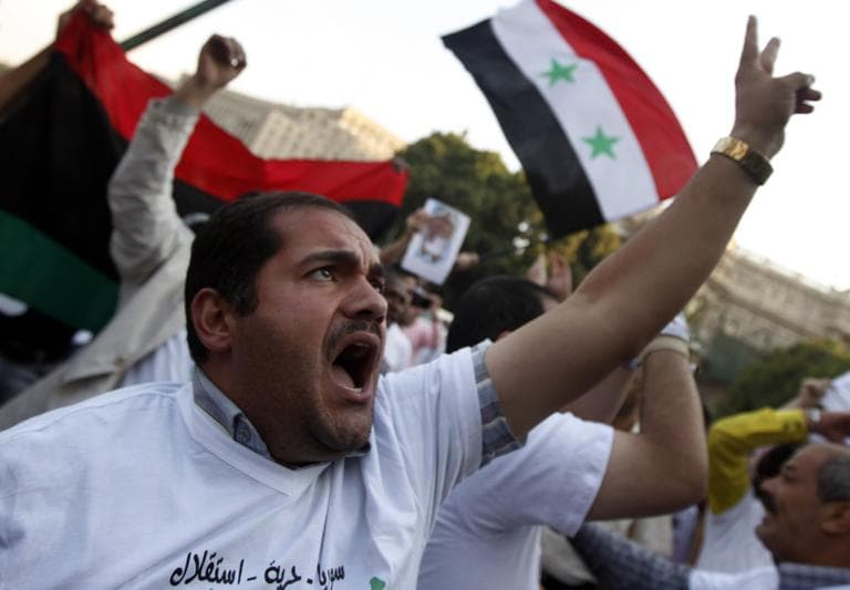 Protesters chant slogans during an anti-Syrian regime protest in front of the Arab league headquarters in Cairo on Sunday. (AP)