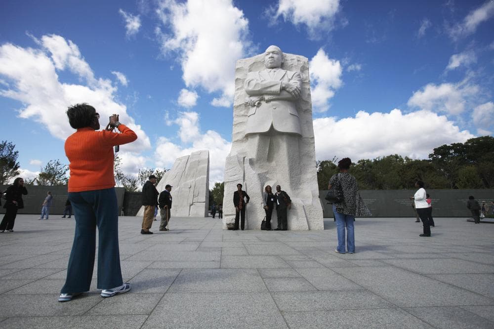 Visitors pose for photos at the Martin Luther King, Jr. Memorial in Washington, Oct. 4, 2011. (AP)