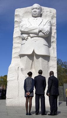 President Barack Obama, his daughter Malia Obama and Harry Johnson, President and CEO of the Martin Luther King Jr. Memorial Foundation, look up at the Martin Luther King Jr. National Memorial on Sunday in Washington. (AP)