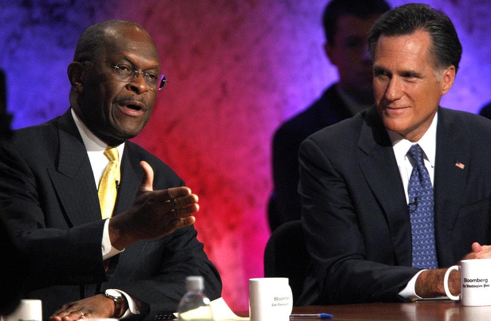 Republican presidential candidates businessman Herman Cain and former Massachusetts Gov. Mitt Romney during a Republican presidential debate at Dartmouth College in Hanover, N.H. (AP)