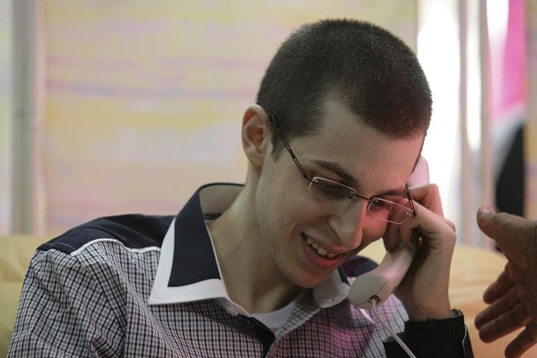 Released Israeli soldier Gilad Schalit talks to his parents on the phone soon after being released from captivity, Tuesday. (AP)