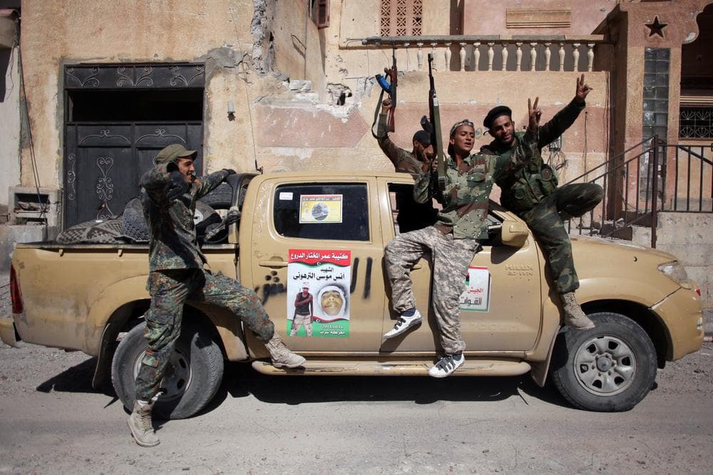 Revolutionary fighters celebrate the capture of Sirte, Libya, Thusday. Officials in Libya's transitional government said Moammar Gadhafi was captured and possibly killed Thursday when revolutionary forces overwhelmed his hometown, Sirte. (AP)