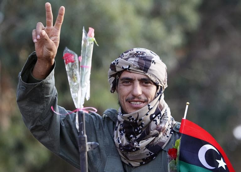 Libyan revolutionary fighter coming back from Sirte is welcomed at the Al Guwarsha gate in Benghazi, Libya, Saturday Oct. 22 (AP)