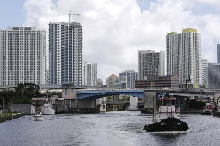 A tugboat heads west up the Miami River in Miami, lined with high-rise condos, mansions and luxury marinas. Developers are looking inland to expand residential construction, particularly along remaining waterfront in areas that have been historically industrial, kicking up property values astronomically. (AP)
