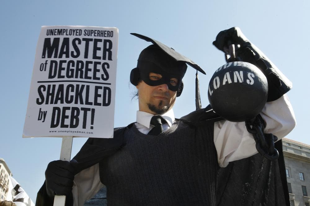 In this Oct. 6, 2011 photo, Gan Golan, of Los Angeles, dressed as the &quot;Master of Degrees,&quot; holds a ball and chain representing his college loan debt, during Occupy DC activities. (AP)