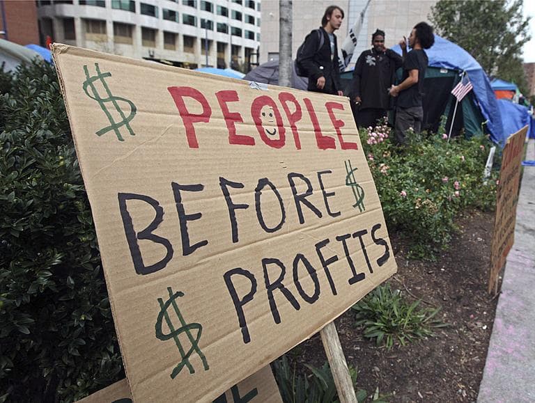 A sign is posted in a garden where protesters from Occupy Boston have set up camp.(AP Photo/Charles Krupa)