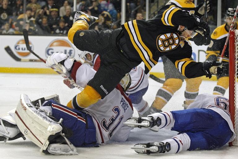Boston Bruins center Patrice Bergeron, top, trips over Montreal Canadiens goalie Carey Price (31)while following his shot in the second period of an NHL hockey game in Boston,Thursday, Oct. 27, 2011. (AP Photo/Charles Krupa)
