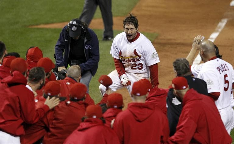Teammates celebrate with St. Louis Cardinals&#039; David Freese after Freese hit a walk-off home run during the 11th inning of Game 6 of baseball&#039;s World Series against the Texas Rangers Thursday, Oct. 27, 2011, in St. Louis. The Cardinals won the game 10-9 to tie the series 3-3. (AP Photo/Eric Gay)