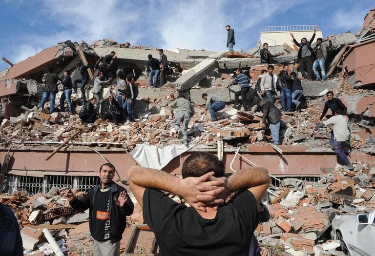 People try to save people trapped under debris in Tabanli village near the city of Van after a powerful earthquake struck eastern Turkey Sunday Oct. 23, 2011, collapsing some buildings and causing a number of deaths, an official said. (AP)