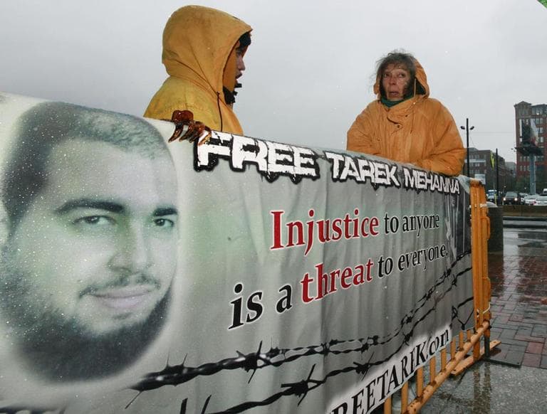 Tarek Mehanna supporters stand in the rain with a sign outside of U.S. District Court in Boston, Oct. 27. (AP)