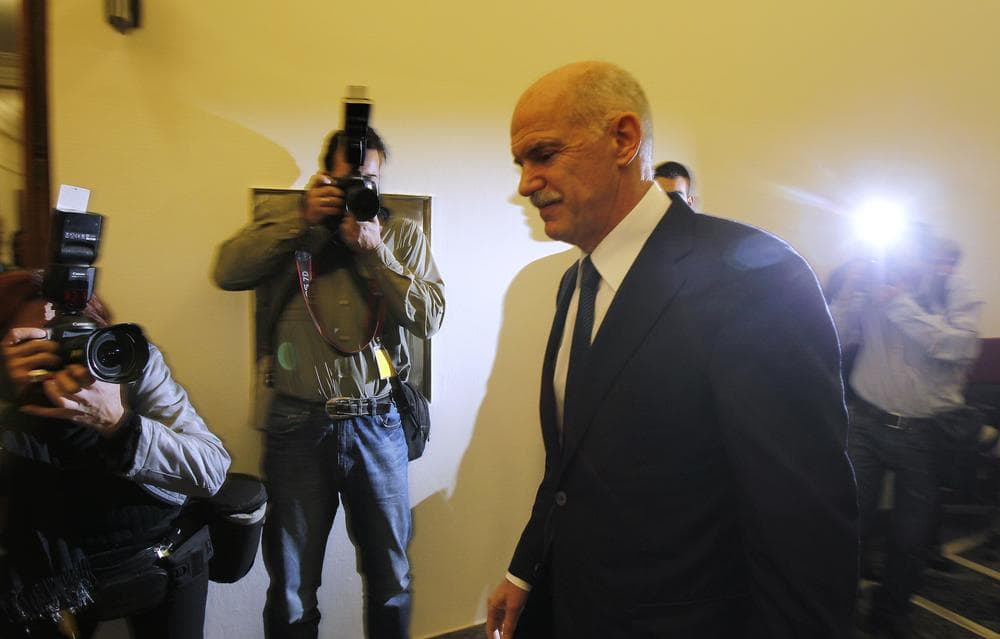 Greek Prime Minister George Papandreou returns to an emergency cabinet meeting after he took a short break at the Greek parliament in Athens, on Thursday. (AP)