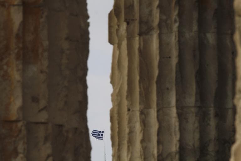 A Greek national flag flies behind columns of the Temple of Olympian Zeus in Athens on Thursday, Nov. 3 2011. (AP) 