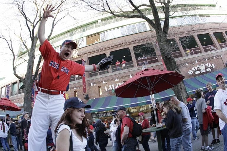 A stilt-walker performs outside Fenway Park before a Boston Red Sox game on April 4, 2010. (AP)
