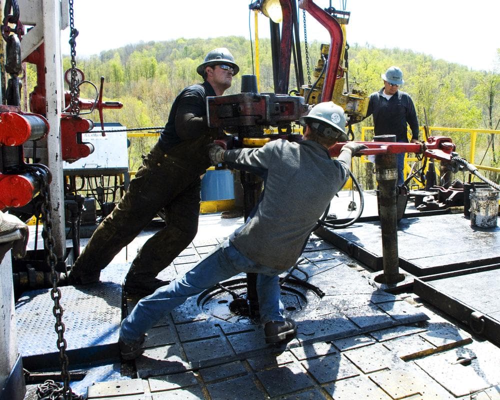 Workers move a section of well casing into place at a Chesapeake Energy natural gas well site near Burlington, Pa. (AP)