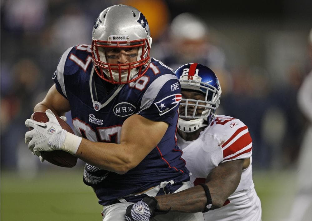 New England&#039;s Rob Gronkowski tries to break free from New York&#039;s Kenny Phillips during the second half of the game in Foxborough, Mass. on Sunday. (AP)
