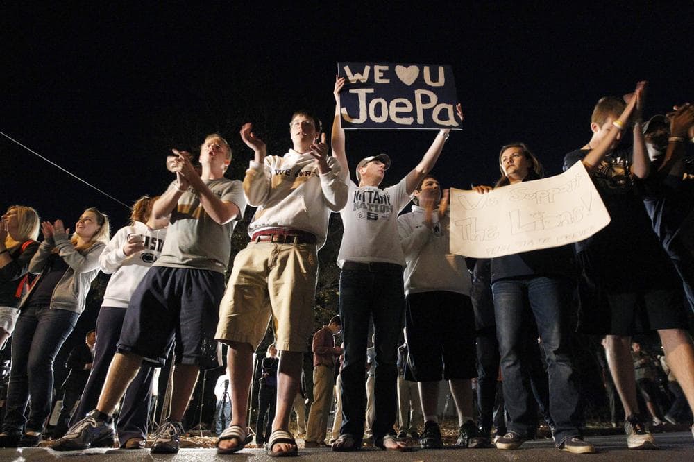 Students rally in support of Penn State football coach Joe Paterno on Tuesday evening in State College, Pa. Paterno's support among the Penn State board of trustees was described as &quot;eroding&quot; Tuesday, threatening to end the 84-year-old coach's career. (AP)
