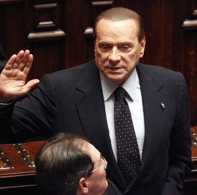 Italian Premier Silvio Berlusconi acknowledges the applause before leaving the Lower Chamber in Rome, Saturday. (AP)