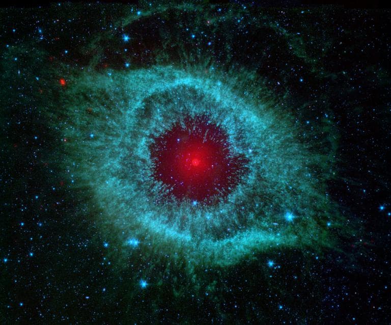 This infrared image from NASA's Spitzer Space Telescope shows the Helix nebula, a cosmic starlet often photographed by amateur astronomers for its vivid colors and eerie resemblance to a giant eye.  (NASA)