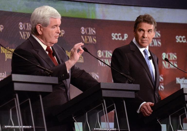 In this Nov. 12, 2011, file photo, Republican presidential candidate Newt Gingrich, left, speaks as fellow candidate Rick Perry looks on during the the CBS News/National Journal foreign policy debate at the Benjamin Johnson Arena, in Spartanburg, S.C. (AP)