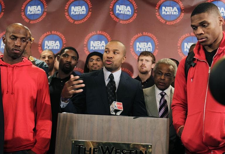 Surrounded by NBA players, including New York Knicks' Chauncy Billups, left, and Oklahoma City Thunder's Russell Westbrook, right, NBA Players Association president Derek Fisher speaks during a news conference after a meeting of the players' union in New York, Monday, Nov. 14, 2011. The NBA players rejected the league's latest offer and have begun the process to disband the union. (AP)