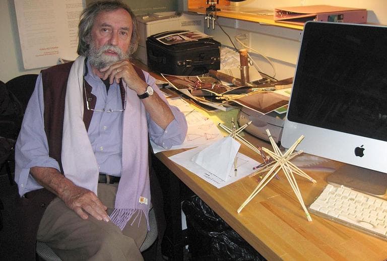 MIT architecture professor Jan Wampler is drafting a redesign of the Occupy Boston encampment to protect it from the cold. The small wood structure on his desk is a model teepee that he believes could be used to slough snow off protesters' tents. (WBUR Photo)