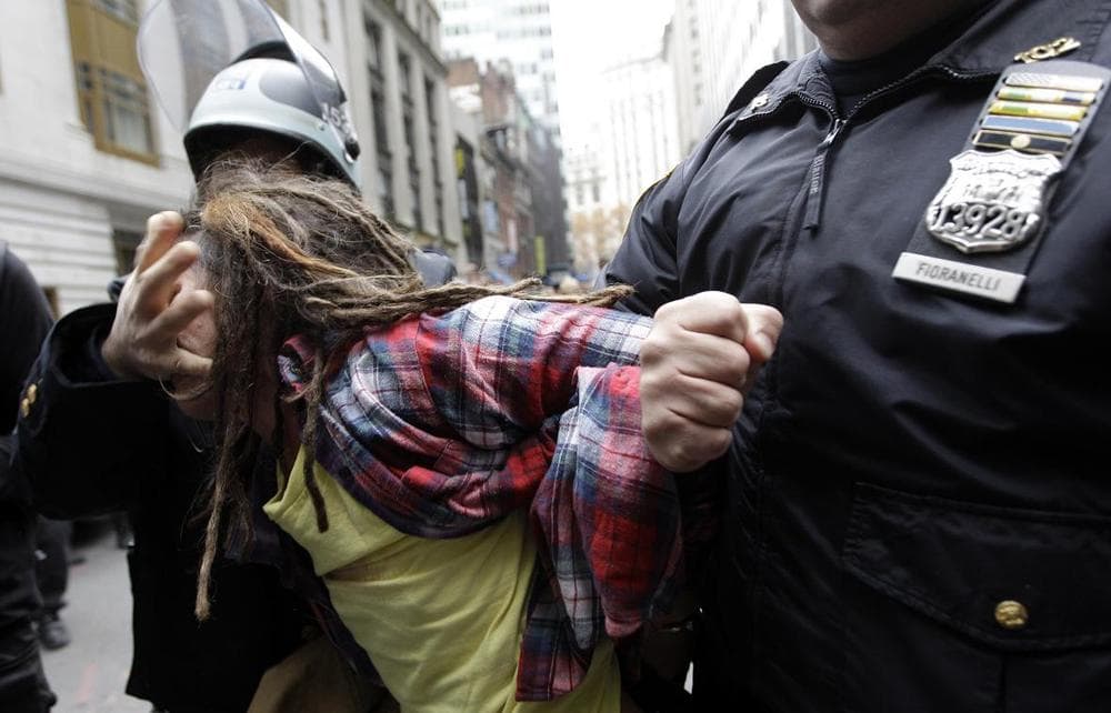 Police officers arrest a demonstrator affiliated with the Occupy Wall Street movement on Thursday. (AP)