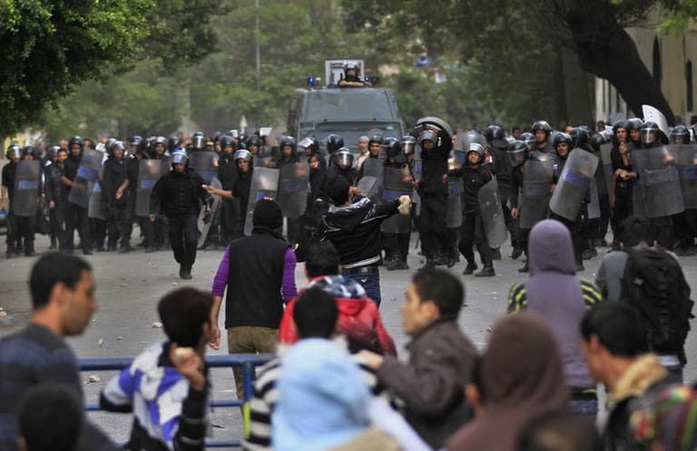 Protesters throw stones at Egyptian riot police during clashes in Tahrir Square in Cairo, Egypt, Saturday. (AP)