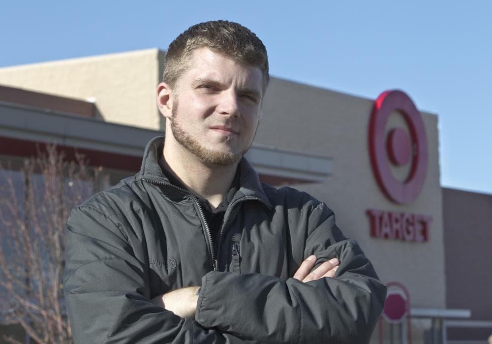 Anthony Hardwick, a part-time employee at a north Omaha Target store, poses for a photo in front of his place of employment. (AP)