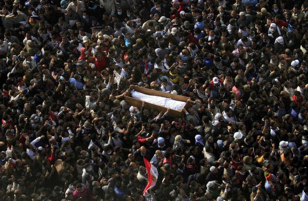 Egyptians carry a body of a protester was killed in clashes with the Egyptian riot police during his funeral at Tahrir square in Cairo, Egypt on Tuesday. (AP)