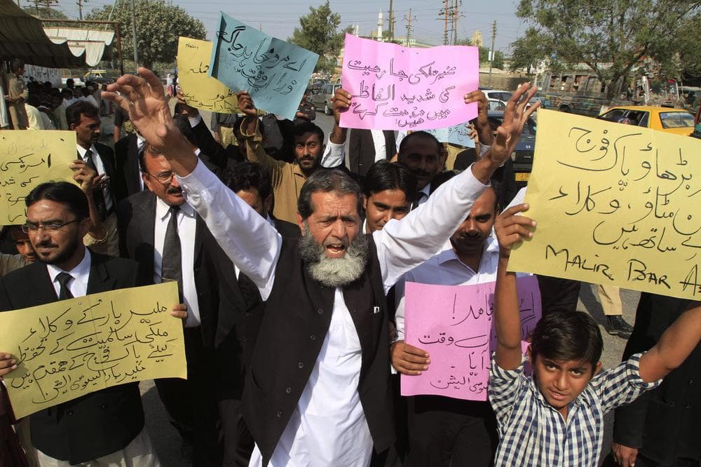 Pakistani lawyers rally to condemn NATO strikes on Pakistani troops, in Karachi, Pakistan, on Monday. Placard on right reads &quot; Go ahead Pakistan army we are with you.&quot;(AP)
