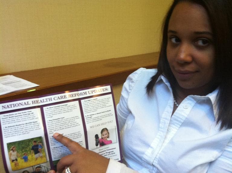 Arelis Gomes points out the free preventive care information in her Health Care for All brochure. (Martha Bebinger/WBUR)