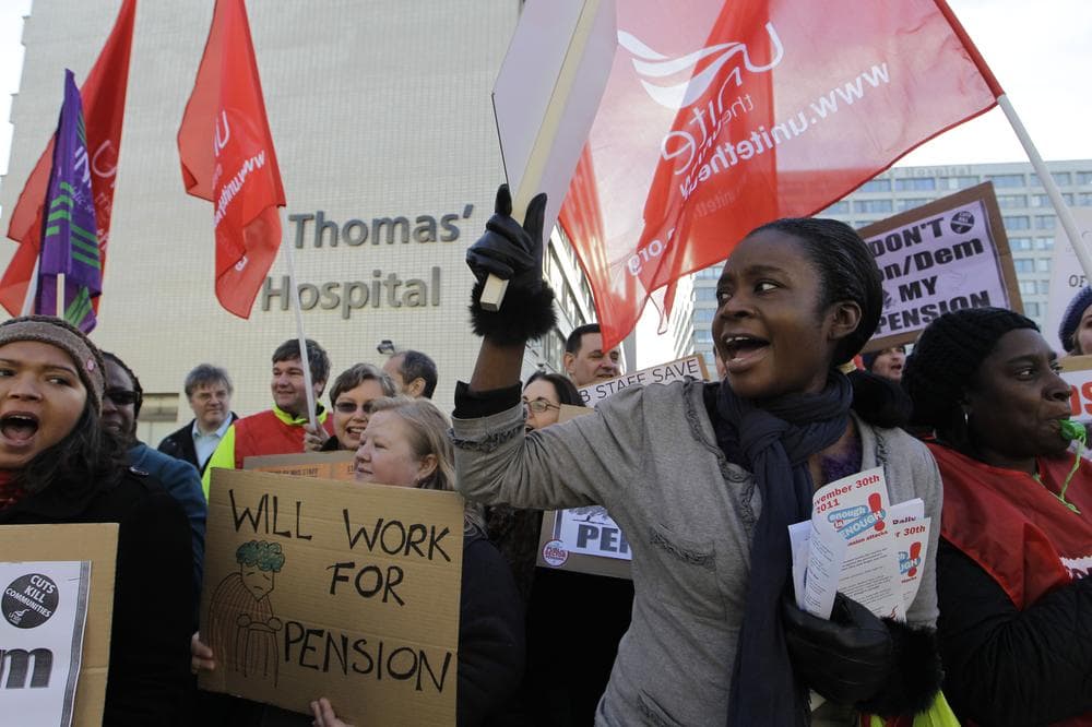 Health workers demonstrate during a strike over pensions, outside St. Thomas&#039; Hospital, London, Wednesday. (AP)