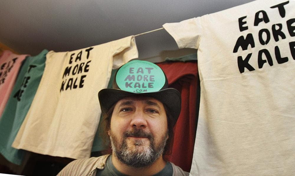 Bo Muller-Moore in his home, the Vermont man who is building a business around the term &quot;eat more kale,&quot; which has been plastered on T-shirts, bumper stickers and other items, is running into opposition from the second largest fried chicken retailer in the country, Chick-fil-A. (AP)