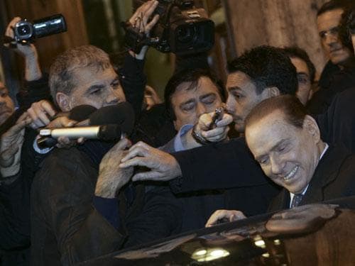 Italian Premier Silvio Berlusconi, right, enters his car at the end of a meeting with his allies in the Italian Senate in Rome, Thursday, Nov. 10, 2011. (AP)