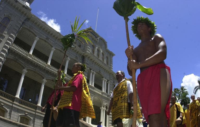 Native Hawaiians march in front of Iolani Palace in Honolulu, Hawaii on September 2, 2002. The march was a celebration of Queen Liliuokalani's birthday.(AP)