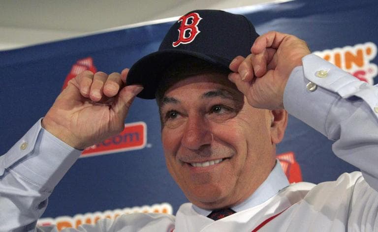 Boston Red Sox manager Bobby Valentine puts on a cap during a news conference at Fenway Park in Boston, Thursday. (AP)