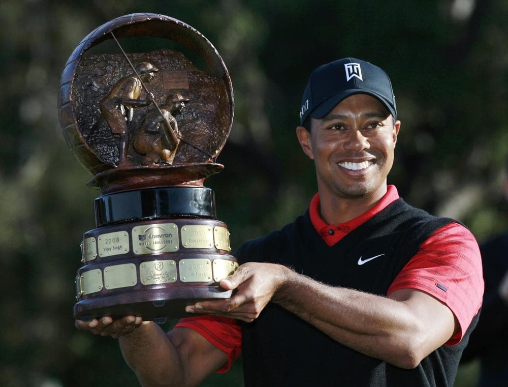Tiger Woods holds his trophy after winning the Chevron World Challenge golf tournament at Sherwood Country Club on Sunday. (AP)