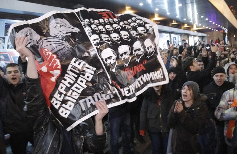 Opposition demonstrators hold a poster reading &quot;Give back the elections, rascals&quot; during protests against alleged vote rigging in Russia's parliamentary elections in Triumphal Square in Moscow, Russia, Tuesday, Dec. 6, 2011. Police clashed Tuesday on a central Moscow square with demonstrators trying to hold a second day of protests against alleged vote fraud in Russia's parliamentary elections. Hundreds of police had blocked off Triumphal Square on Tuesday evening, then began chasing about 100 demonstrators, seizing some and throwing them harshly into police vehicles. (AP)