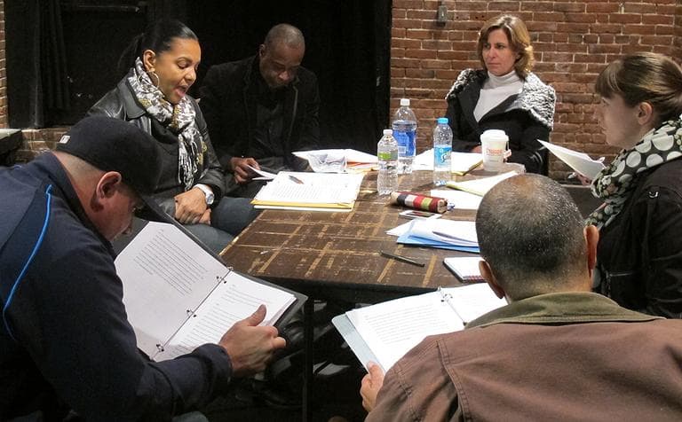 The actors go over the scripts for their performance. (Andrea Shea/WBUR)