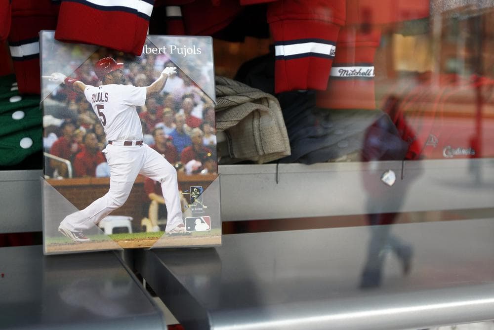 A picture of Albert Pujols was still displayed in the window of a St. Louis Cardinals merchandise store on Thursday, the day that the three-time NL MVP announced he's agreed to a 10-year contract with the Los Angeles Angels. (AP)