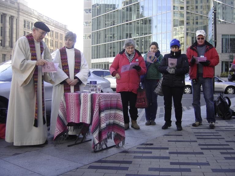 Members of Occupy Boston celebrate Mass Sunday morning in Dewey Square. (Kathleen McNerney/WBUR)