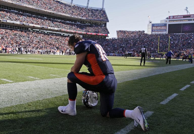 Denver Broncos quarterback Tim Tebow (15) kneels and prays before the start of an NFL football game against the Chicago Bears, Sunday, Dec. 11, 2011, in Denver. (AP)