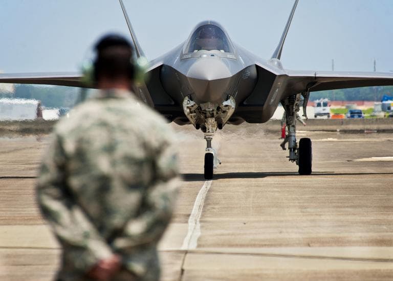 In this photo taken on July 14, 2011 and released by U.S. Air Force, Tech. Sgt. Brian West watches an F-35 Lightning II approach for the first time at Eglin Air Force Base, Fla. (AP)