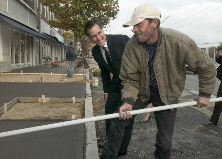 In this 2004 file photo, Gov. Mitt Romney talks with cement worker Gilberto Teves during a walk through of Hyannis. (AP/Cape Cod Times)